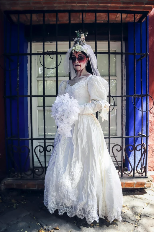 a woman in white gown holding her arms around her body