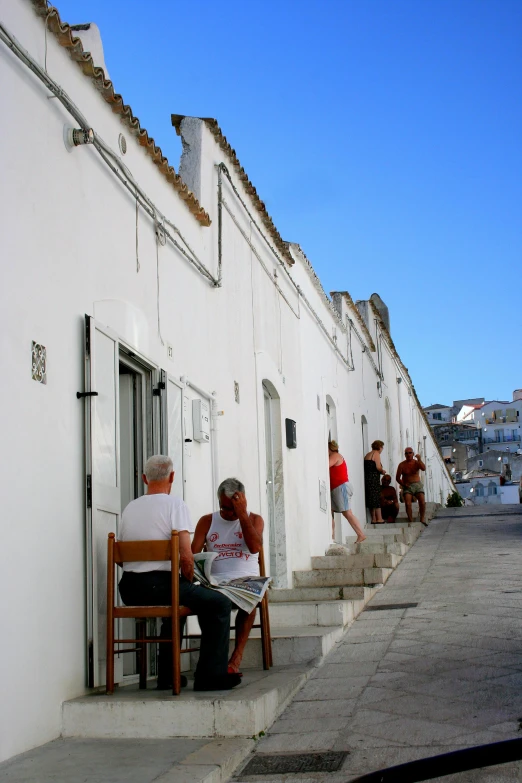 people sitting outside in their home on stairs