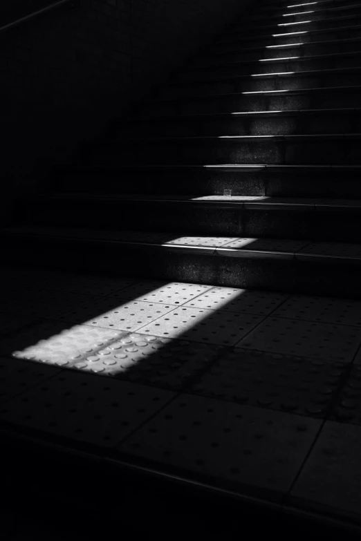 a staircase leading up to a dimly lit stairwell