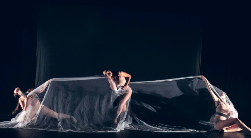 dancers dressed as ghostes are on a stage