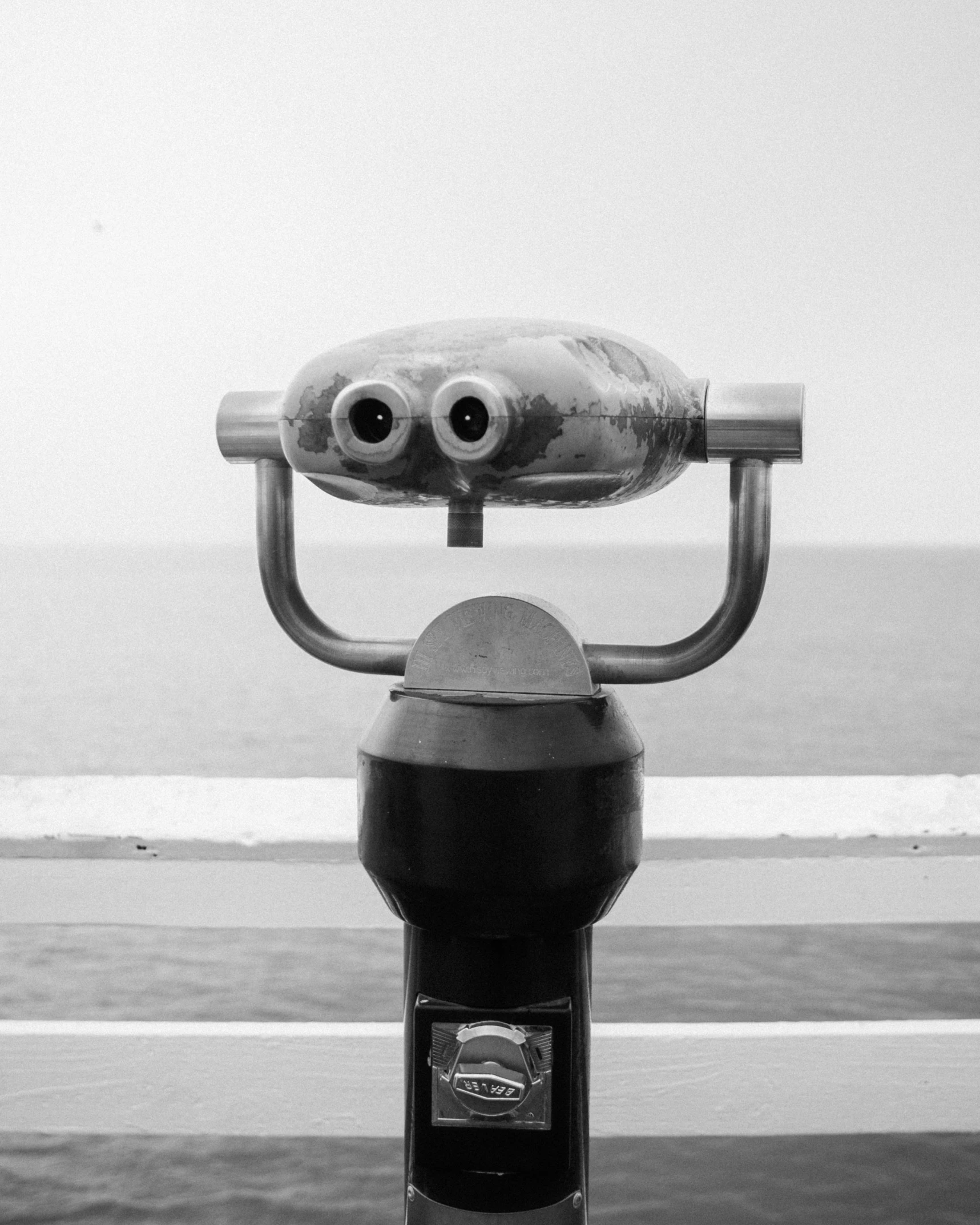 a close up of a parking meter near a body of water