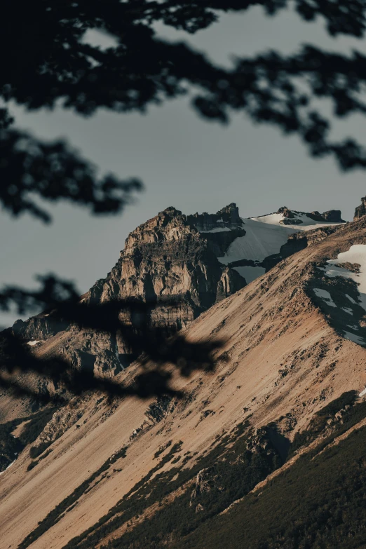 two mountains in the distance are covered with snow