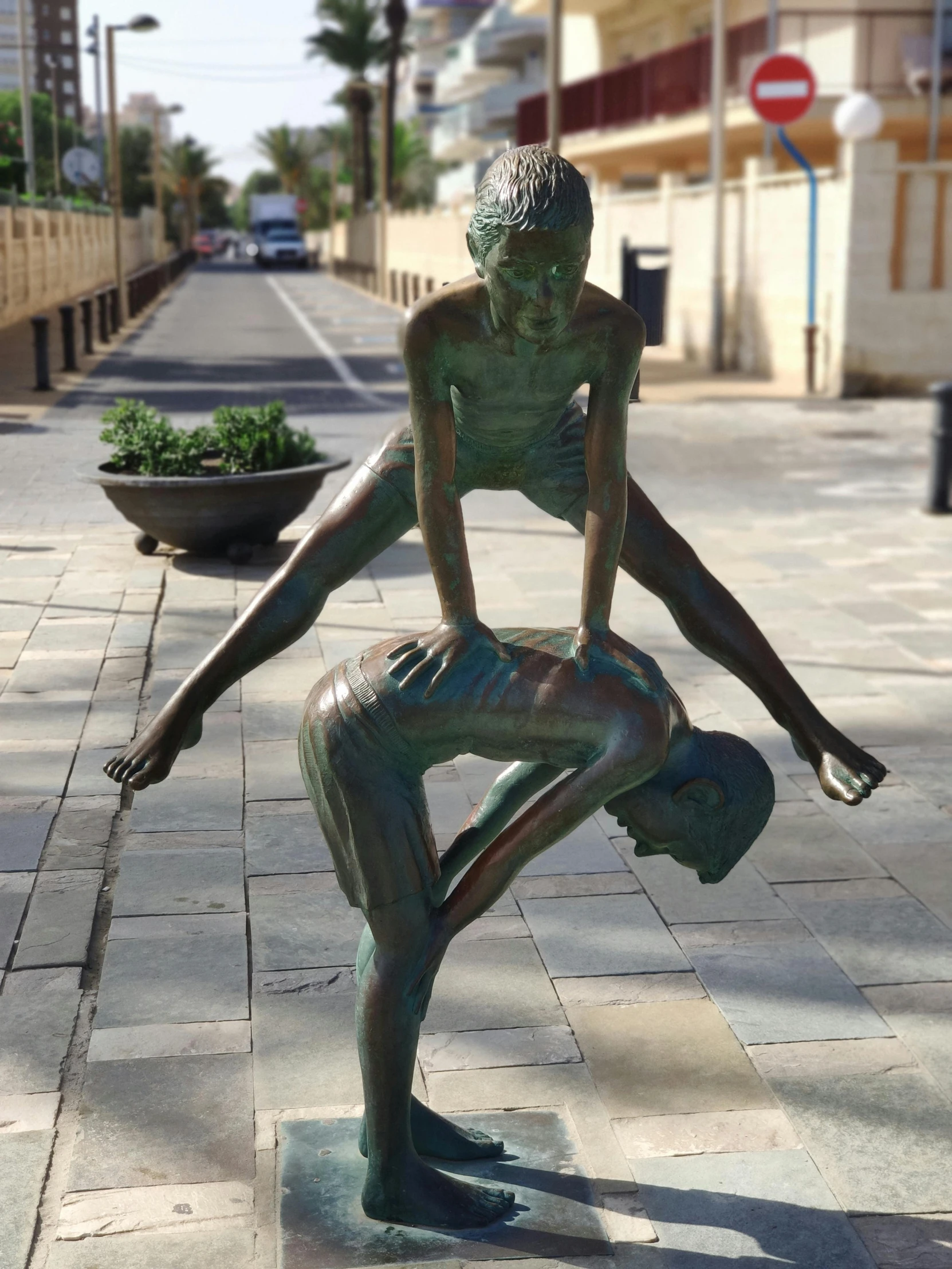 the bronze statue of a woman is leaning on a rock