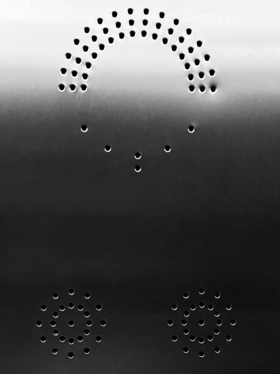 some round holes in a steel surface