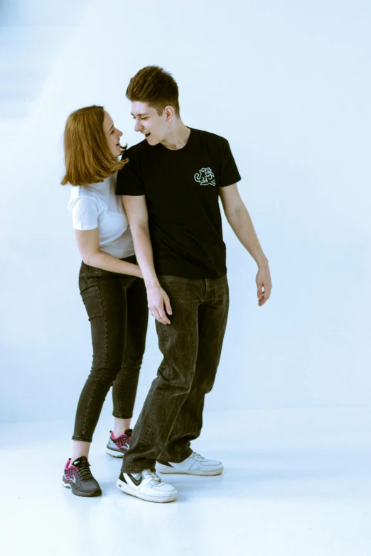 a woman and a man on skateboards together