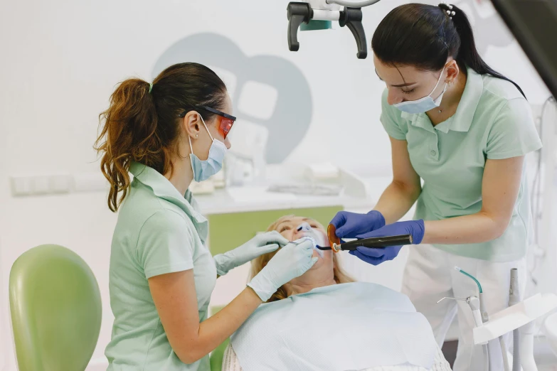 two women with gloves in an operating room