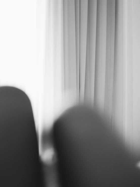 black and white pograph of chairs in front of a window