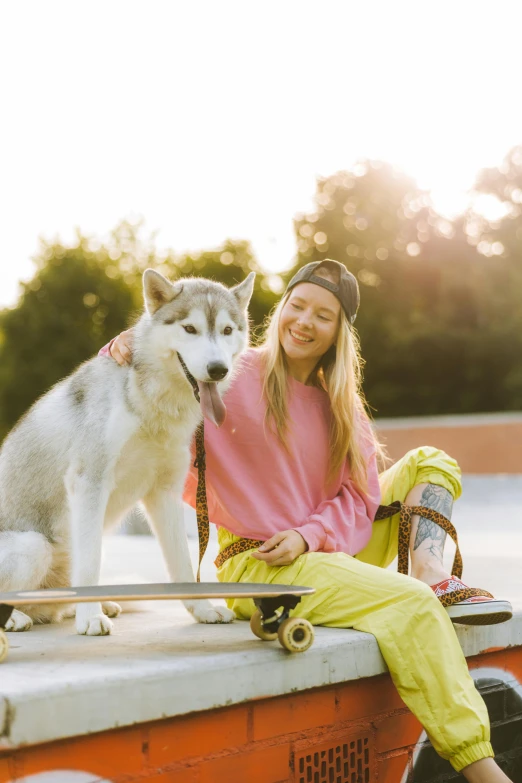 a woman sits next to a large dog on a cart