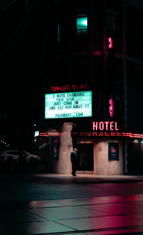 a el is lit up at night with neon signs