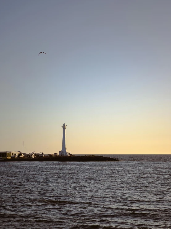 two large boats and a lighthouse on the ocean