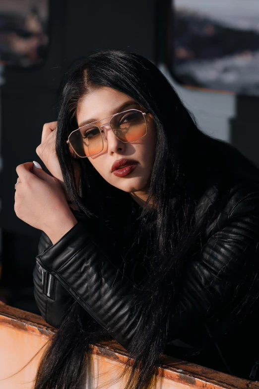 a woman in glasses leaning on a window