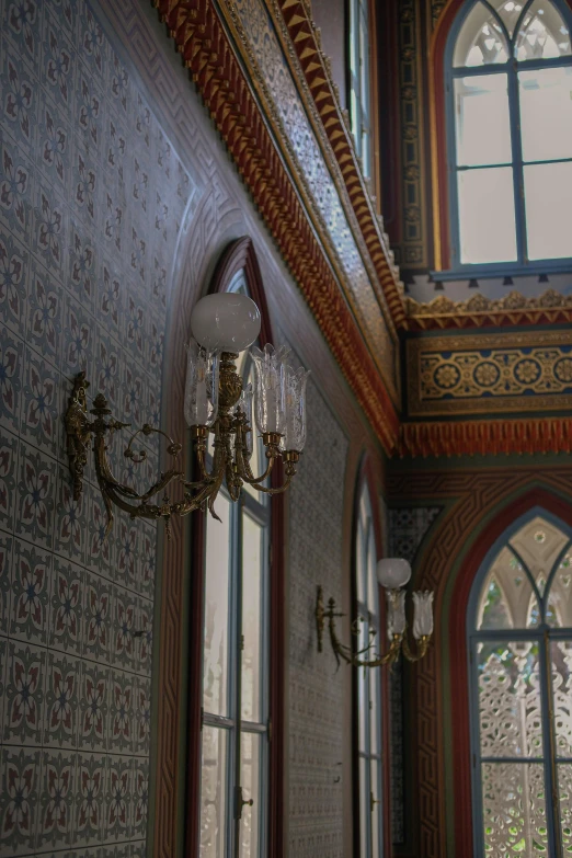 this is a chandelier and windows in a large room