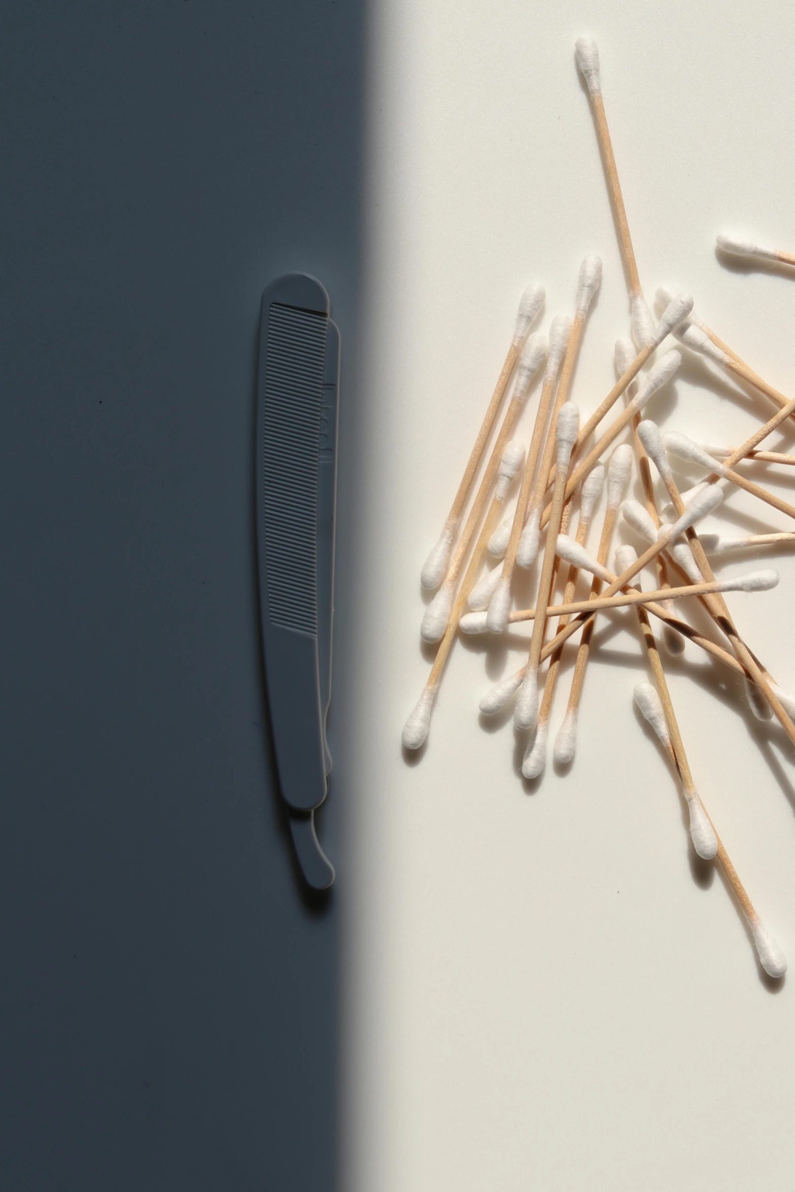 a white comb on top of matches on the table