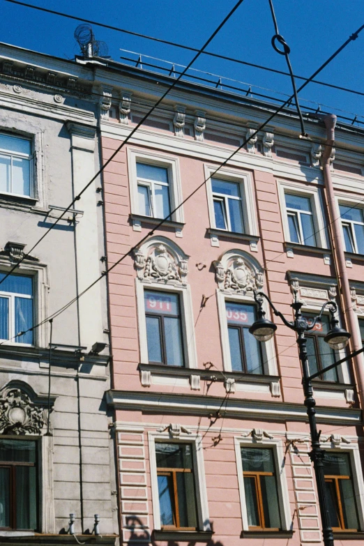 a couple of pink buildings are against a blue sky