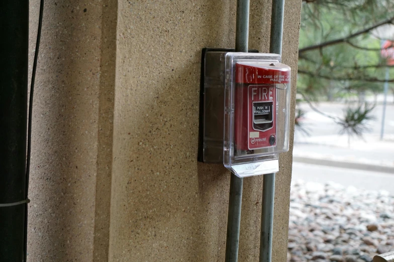 the red phone has been placed on the side of a building