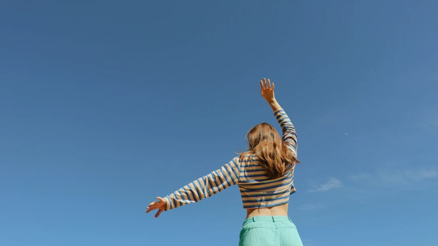 a girl holding a frisbee in the air