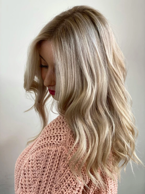 a woman with blond hair styled by a professional hair stylist