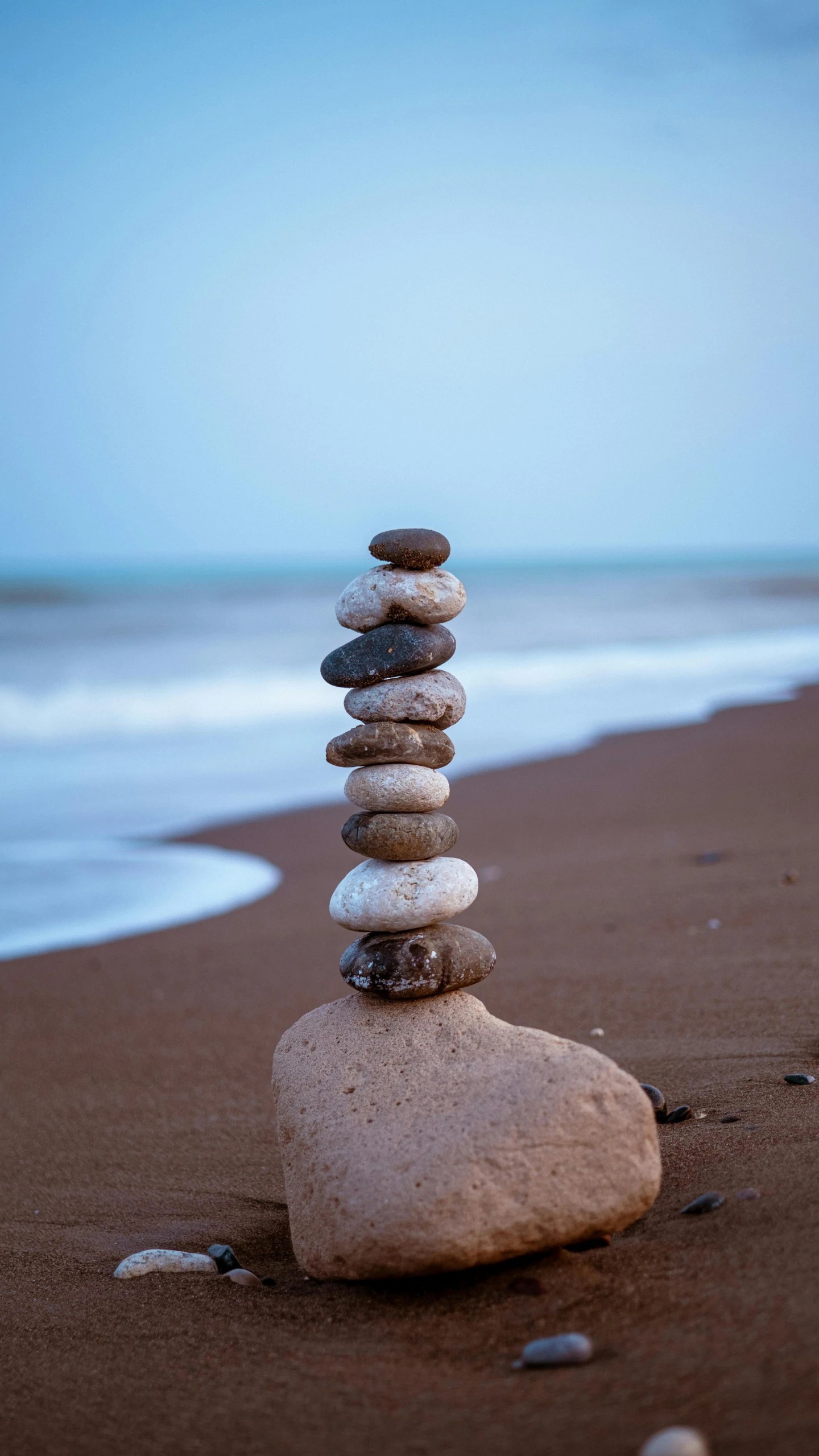 rocks stacked on top of each other at the edge of the water