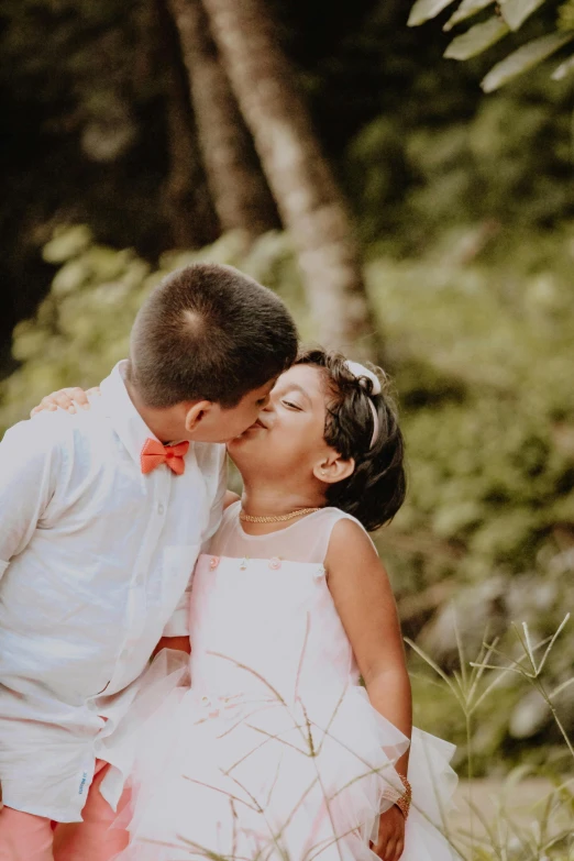 a  kissing a little girl in the woods