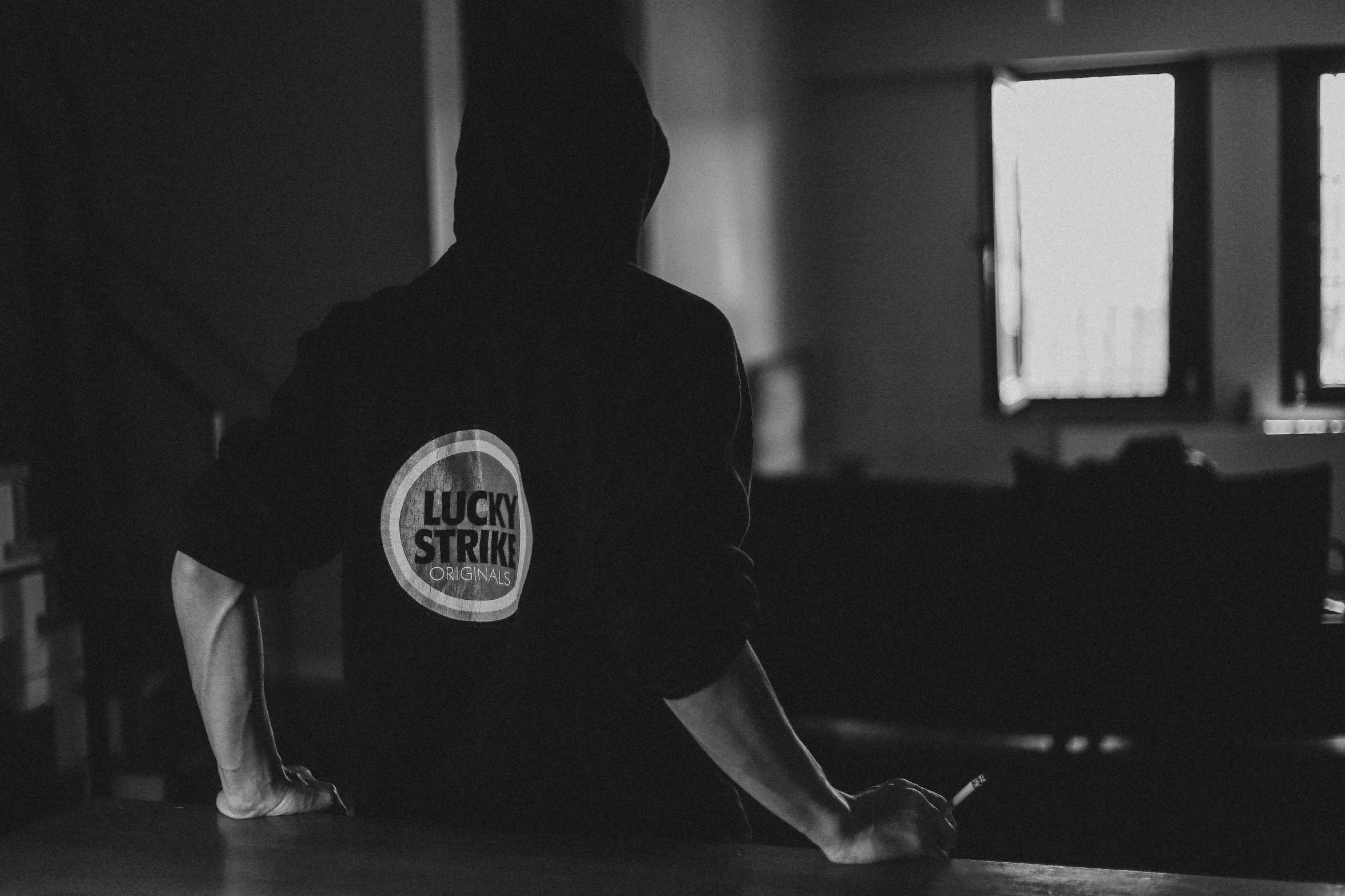 a man stands on a kitchen counter while looking out the window