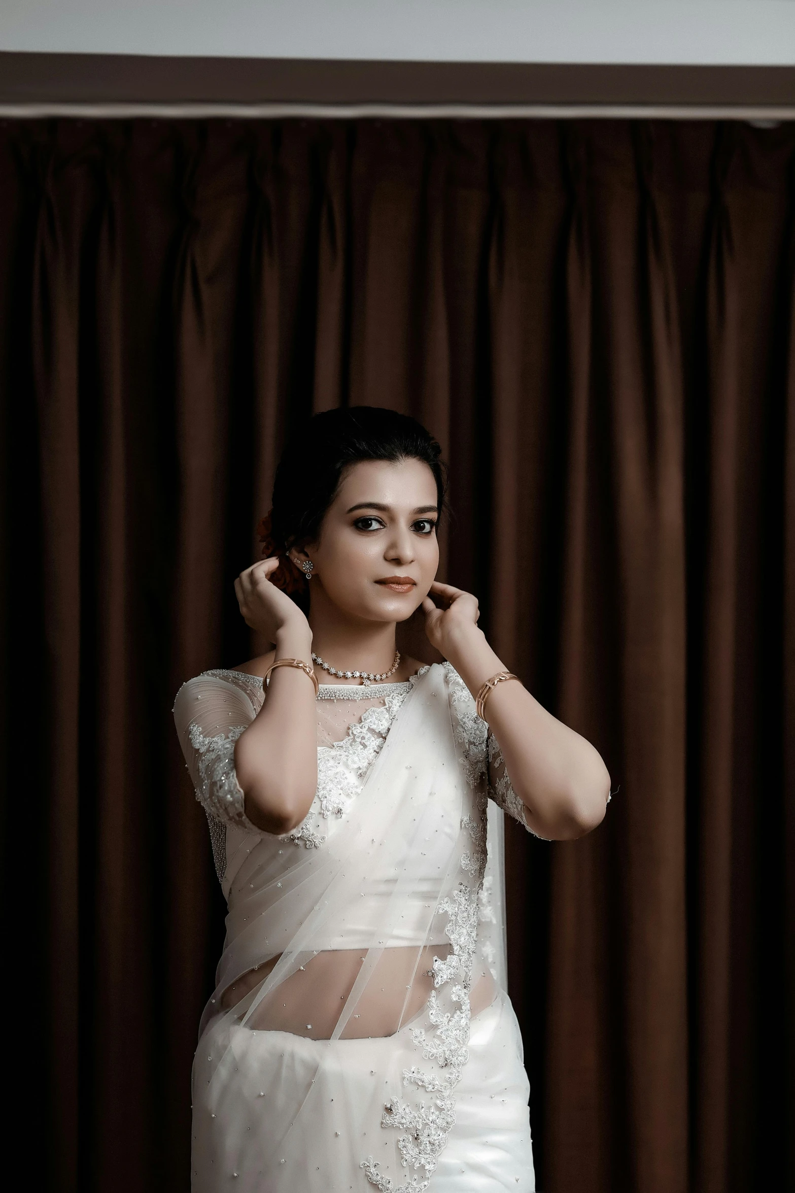 a woman is posing in a white outfit