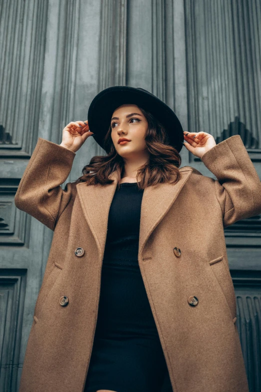 a beautiful woman posing for the camera in front of a building