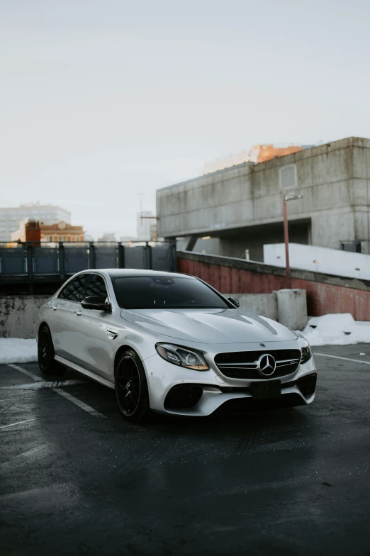 a white mercedes parked in a parking lot