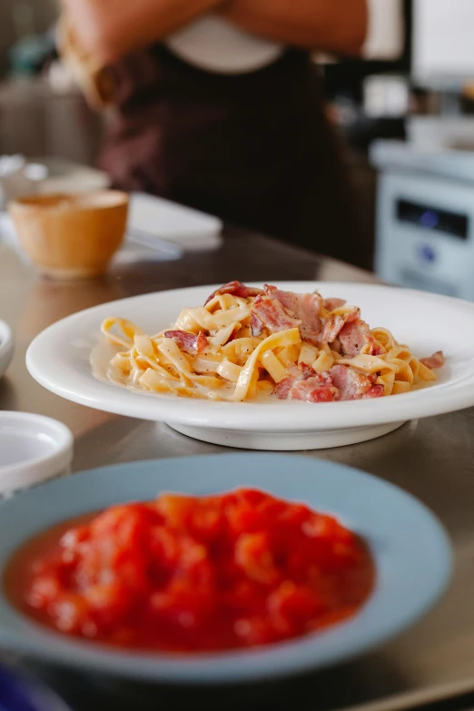 a plate full of some pasta with tomato sauce