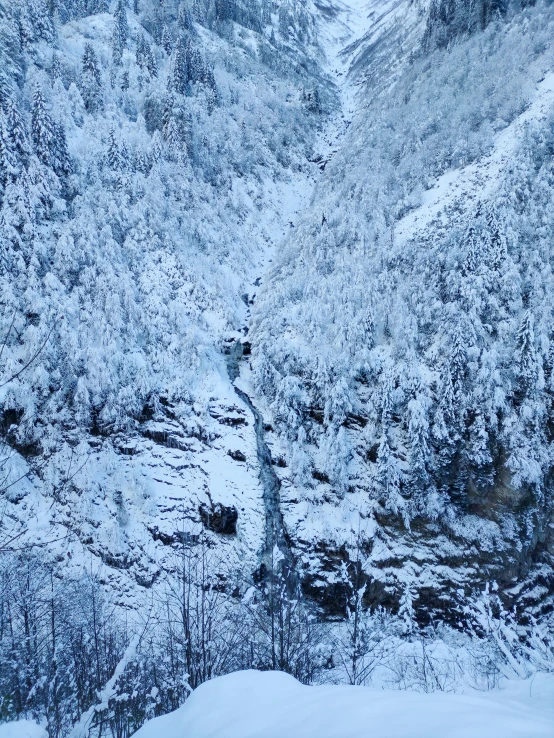 snow covered mountain and river area during the day