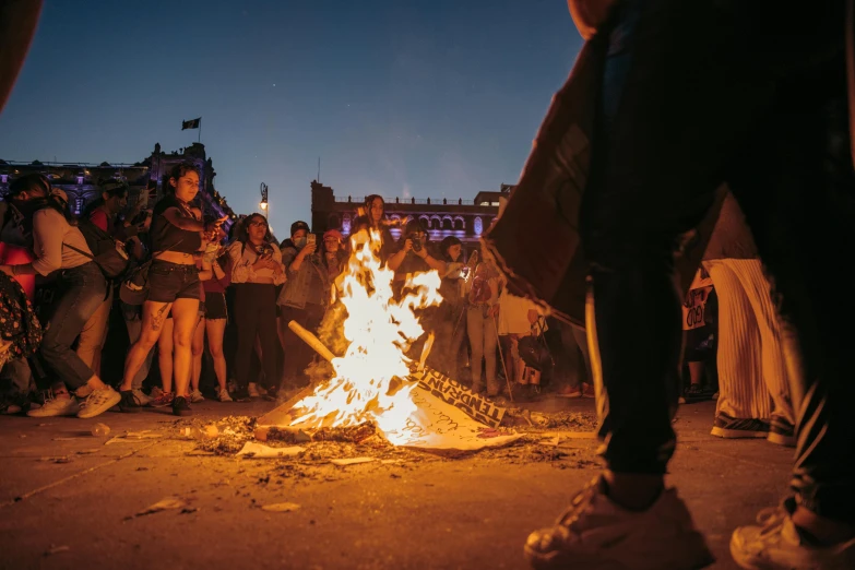 people watch the flame being lit at night