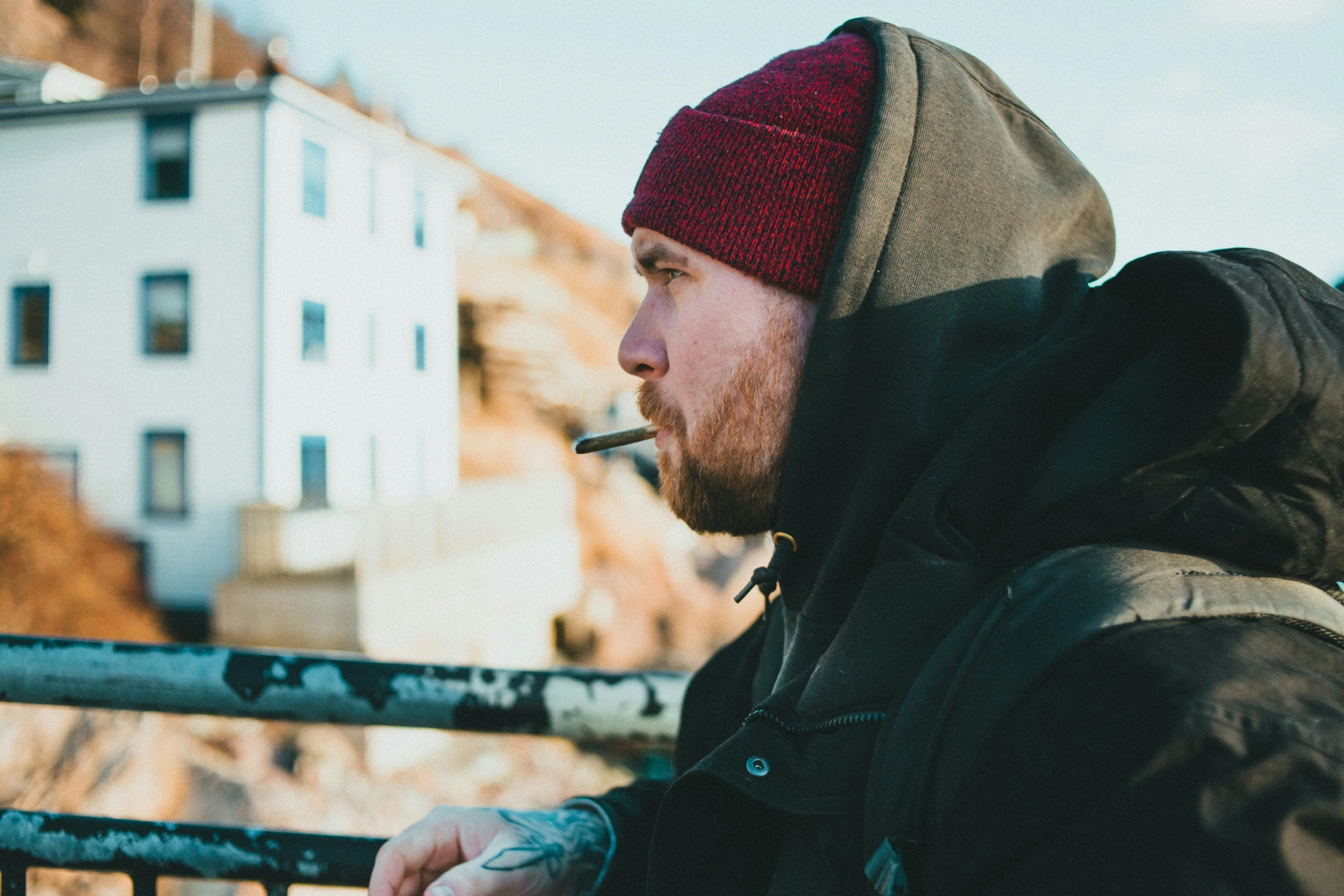 a man with a beard is smoking a cigarette