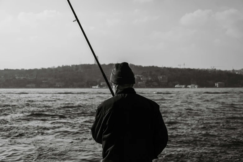 a person fishing off of a boat on water