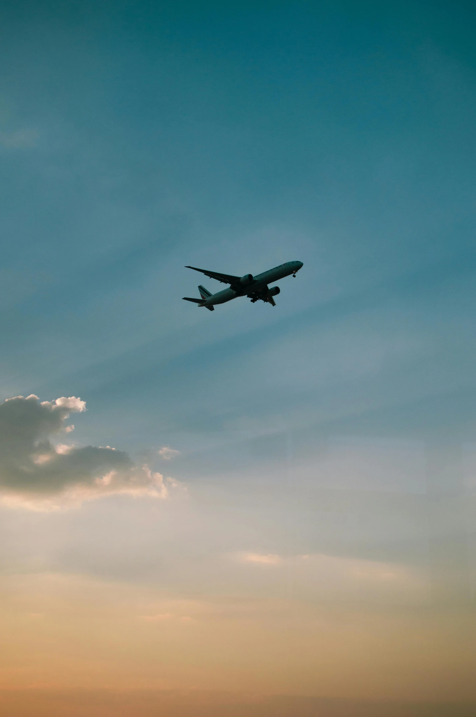 a airplane flying through a cloudy blue sky