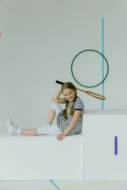 a little girl is sitting on top of a structure