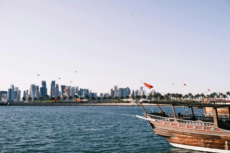 a boat is in the water with the city skyline in the background