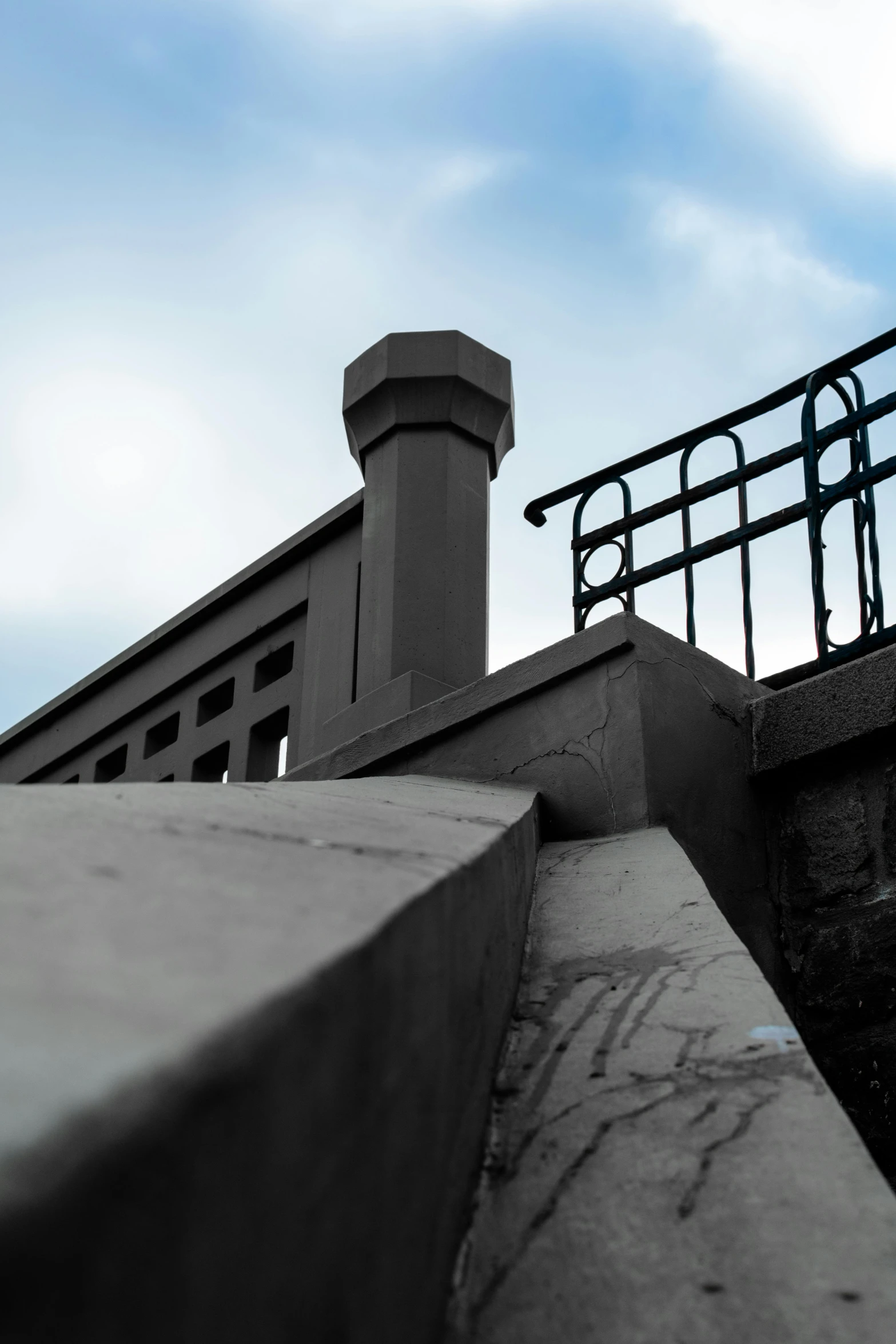 a guard rail over a concrete wall near a bridge