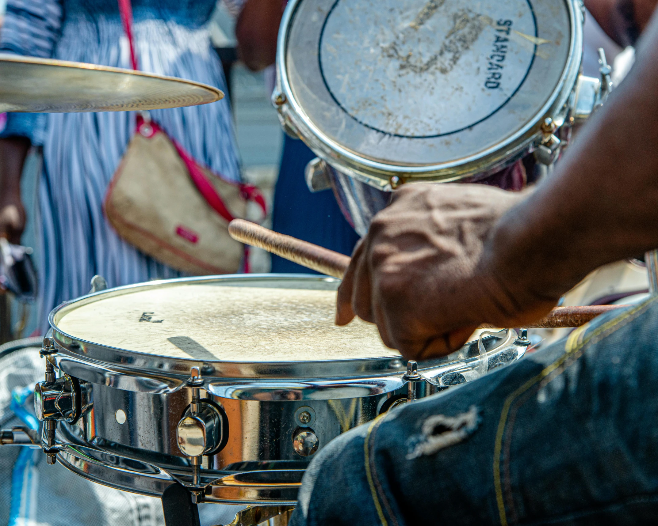 a man that is sitting in front of a drum set