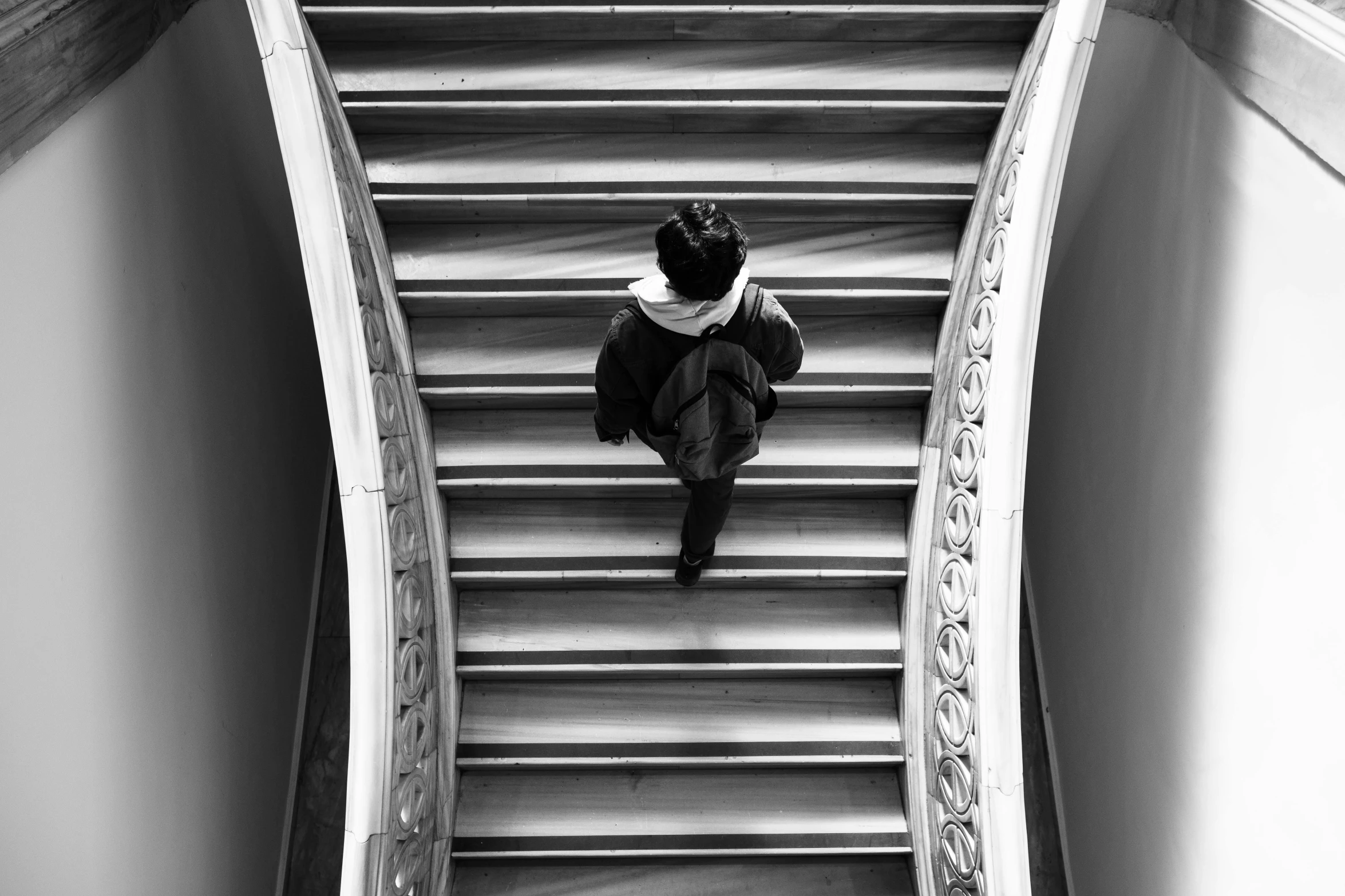 a man walks up the stairs of an escalator