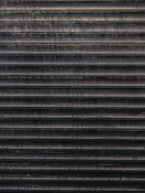 the back of a black colored closed roof is partially covered with a layer of rain