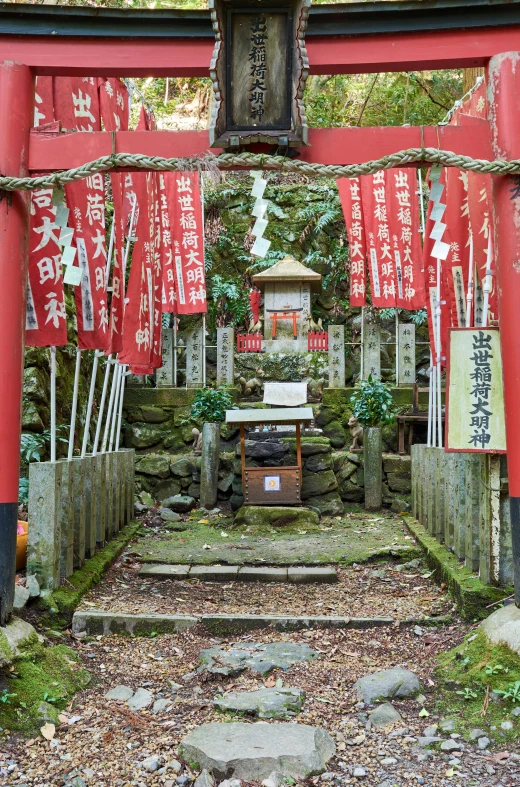 an asian gate with many red flags and signs