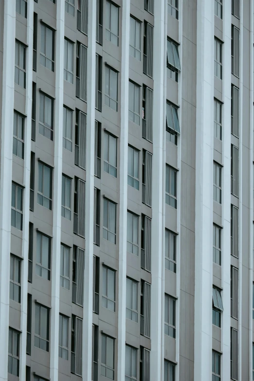 a building with white windows with curtains and some signs