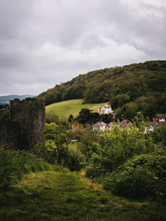 the view of some houses on a mountain in a field