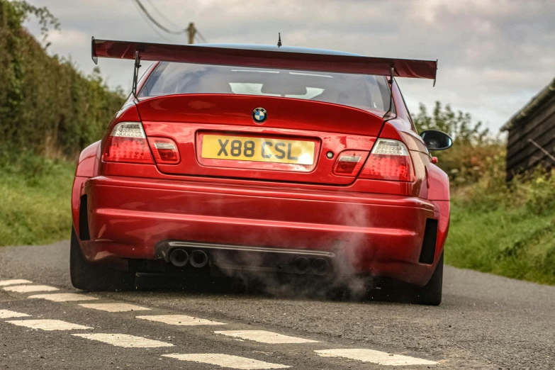 the back end of a red car is seen