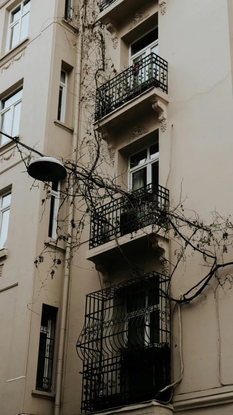 a tall building with balconies on the upper story