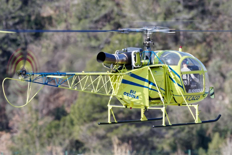 a small helicopter flying close to the ground