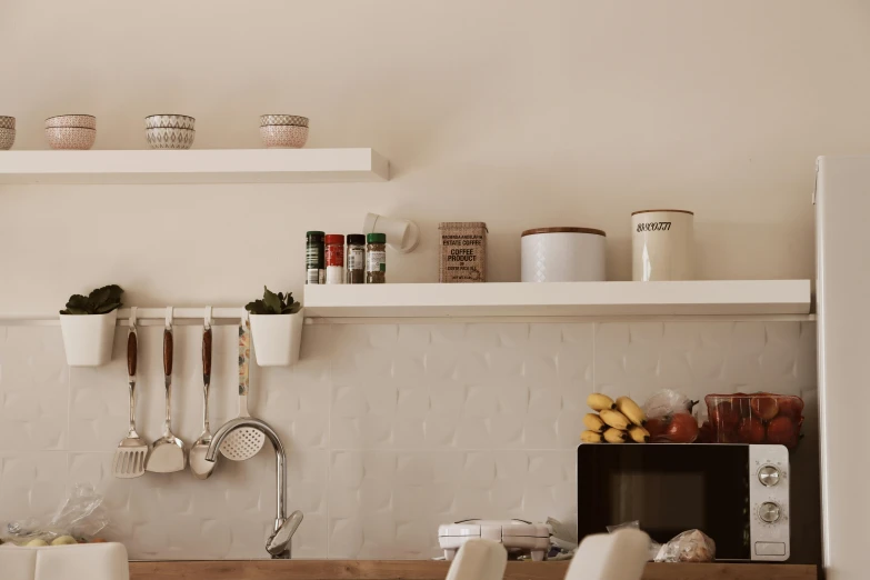 kitchen with shelves and cooking utensils on a shelf