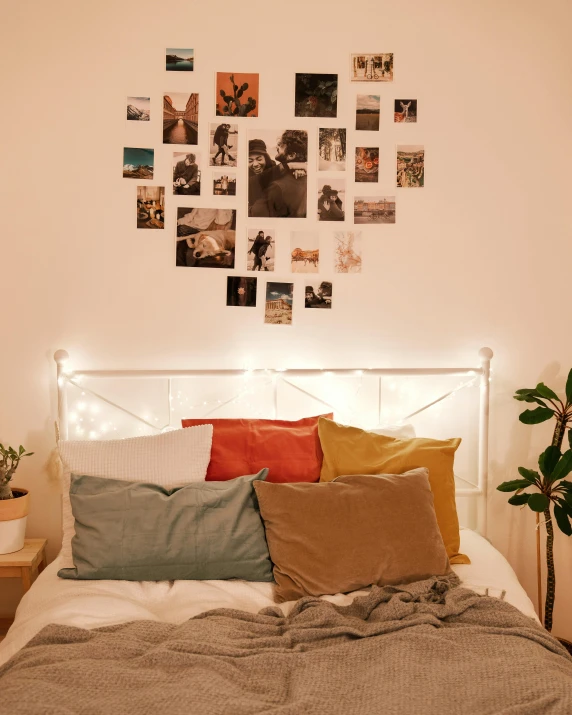 a bed with pillows, blankets, and string lights