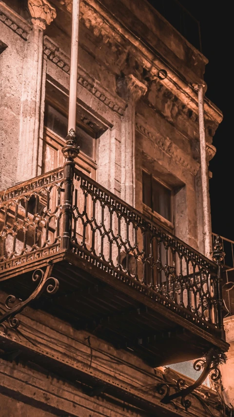 a balcony and balconies at night outside of an old building