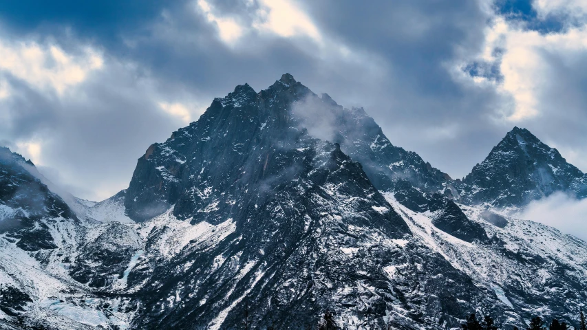 the top of a mountain with a cloudy sky