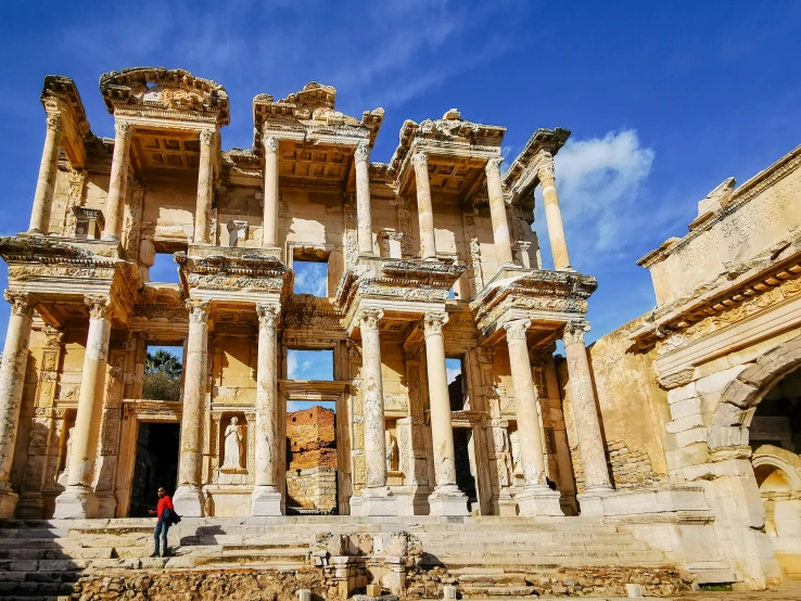 a person standing in front of a large old building